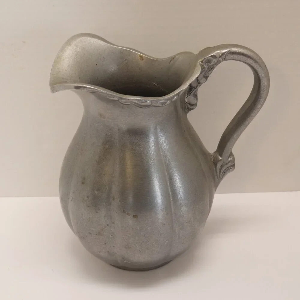 A Heavy Pewter Water Pitcher Pre Owner with some signs of wear